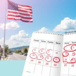 American flag waving gently with red circled dates on a planner in front of pastel sky and blurred city streets.