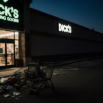 Abandoned cart lies with scattered merchandise and looming dark shadow over Dick
