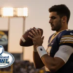 Diego Pavia holds a football and looks down at it with determination under a sunset sky reflected by stadium lights