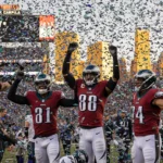 Eagles players celebrate with confetti raining and a scoreboard showing 31-0 in the background.