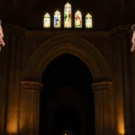 Governor Josh Shapiro and Governor Spencer Cox seated with light from stained glass illuminating an archway at the Cathedral