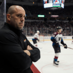Travis Konecny stands with arms crossed looking at Rick Tocchet who fumes behind the bench with score showing 3‑2 loss in hoc