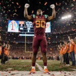 Malachi Toney stands triumphantly in the end zone with confetti and balloons while Miami fans in burnt orange cheer.