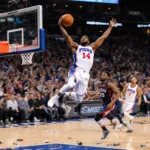 MarJon Beauchamp dunking midair with 76ers jersey #14 and cheering crowd in background
