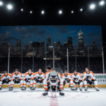 Philadelphia Flyers players huddle around empty chair with city skyline visible behind dim arena