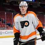 Rasmus Ristolainen standing on ice with Philadelphia Flyers jersey number 8 and hockey stick poised against Bell Centre backg
