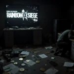 Defeated avatar slumps over desk with flickering Rainbow Six Siege logo on monitor and game over screen