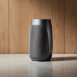 Samsung Music Studio Wi‑Fi speaker gleams with soft diffused light and subtle reflections on a neutral gray background.