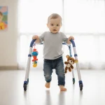 Toddler taking first steps with walker and holding stuffed animal in bright pediatric rehab room at Children