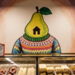 Stylized pear wearing sweater swirling above Trader Joe