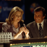 Vanna White sits beside empty Pat Sajak chair holding microphone with warm studio lights and calendar hinting retirement.