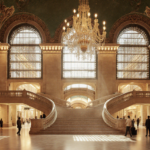 Wanamaker Building stands with Beaux-Arts facade and golden light revealing interior staircase
