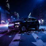 Black Jeep Compass veering wrong way on Oxford Street with debris and crumpled metal near intersection under night lighting