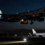 Air Force One lands with sparks on wingtip and C-32 aircraft waiting nearby at Joint Base Andrews