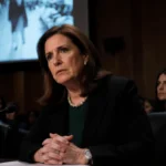 Rep Chrissy Houlahan testifying at congressional hearing with video projection flickering behind her