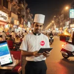 Waiter carries tablet with Eat App logo amid Mumbai night market with phones orders and Swiggy rider on scooter delivers meal