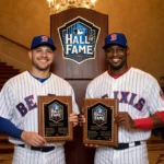 Carlos Beltrán and Andruw Jones smiling together holding up Hall of Fame plaques at baseball