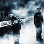 Person typing on laptop with blank screen showing error message