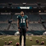 Jalen Hurts stands on football field with Philadelphia Eagles logo blurred behind and scattered equipment showing team identi