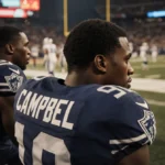 Jihaad Campbell sitting on NFL bench with Nakobe Dean standing nearby and stadium lights casting warm glow over field