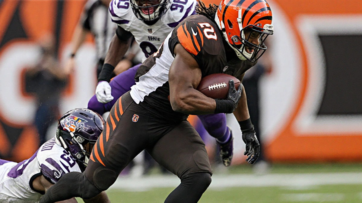 Myles Garrett breaking through Orlando Brown Jr.'s block with tackle and Joe Burrow to the ground Bengals sideline blurred