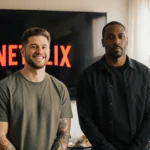 Pete Davidson stands with Michael Irvin near Netflix screen showing their friendly creative energy