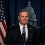 Governor Phil Murphy delivers final State of the State address with New Jersey flag and Capitol building behind him
