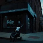 Man walking down Nelson Street with menacing glance over shoulder and abandoned stroller with baby