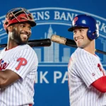 J.T. Realmuto and Rhys Hoskins high-fiving with Phillies jerseys and bats at Citizens Bank Park