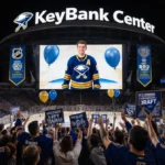 Buffalo Sabres fans cheer outside KeyBank Center with Gavin McKenna on screen and Bills signs waving