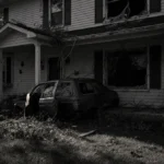 SUV crashed into suburban house porch with shattered window and debris scattered across overgrown lawn