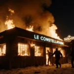 Patrons fleeing a burning Swiss Alpine bar with flames and smoke and neon sign.