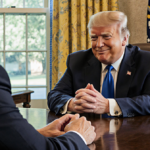 Donald Trump sits at a large wooden desk with Governor Tim Walz across polished wood under soft golden lighting and warmth