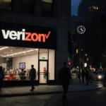 Verizon store glows softly at night with people walking away showing relief and frustration on dark city street