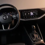 Volkswagen ID.Polo dashboard displays tactile controls with warm lighting and a non-circular steering wheel