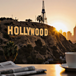 Hollywood sign shines with Warner Bros. golden letters and city skyline at dusk