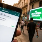 Person walks away from phone showing WhatsApp error with Meta billboard and city street in background